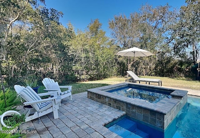 view of swimming pool featuring an in ground hot tub and a patio