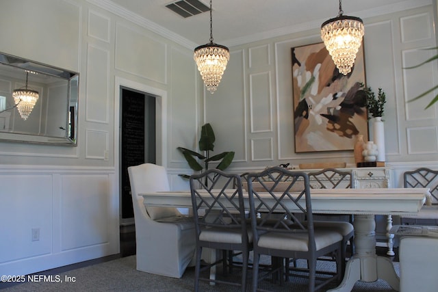 dining space featuring an inviting chandelier and a decorative wall