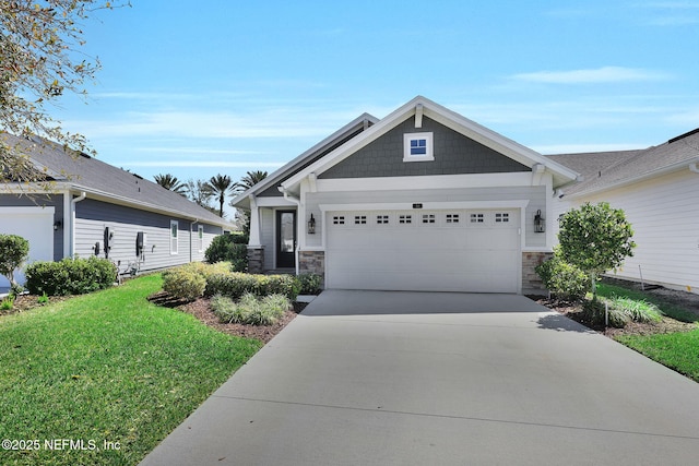 craftsman inspired home featuring stone siding, an attached garage, concrete driveway, and a front yard