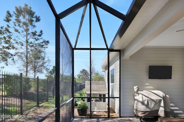 sunroom featuring beamed ceiling