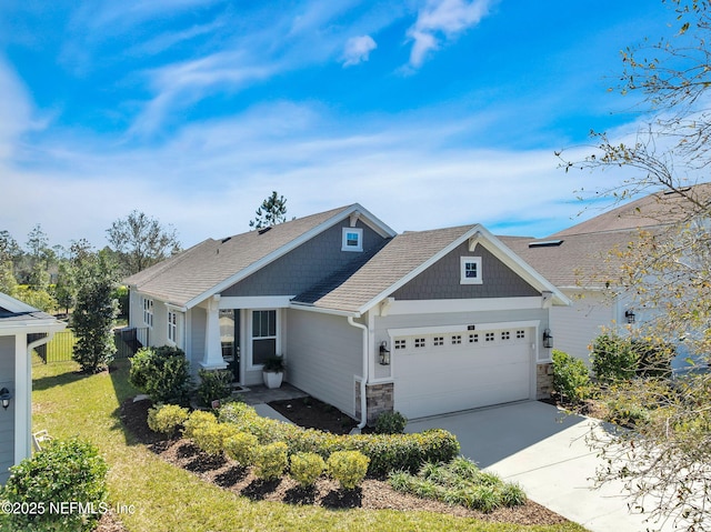 craftsman-style home with a front lawn, stone siding, fence, concrete driveway, and an attached garage