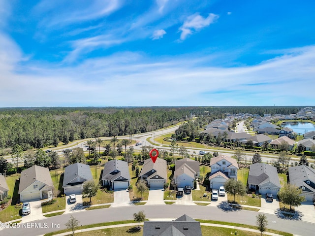 bird's eye view featuring a residential view and a forest view