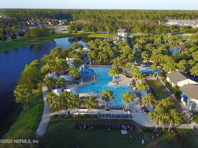 aerial view featuring a wooded view and a water view