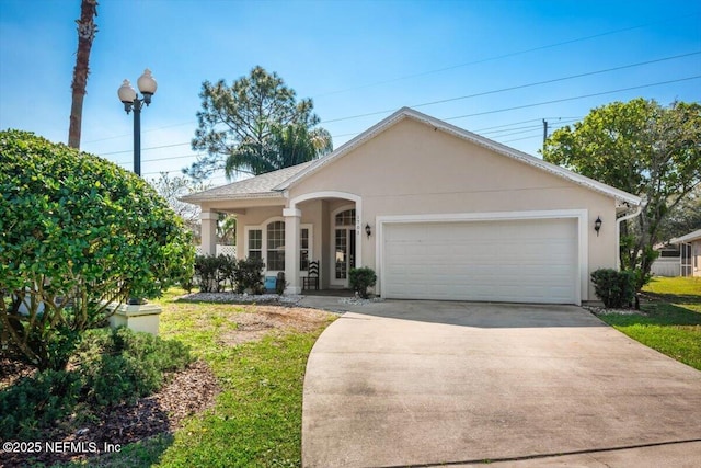 view of front facade featuring concrete driveway, a porch, an attached garage, and stucco siding