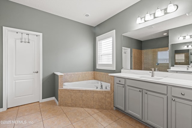 bathroom with a garden tub, tile patterned flooring, walk in shower, and vanity