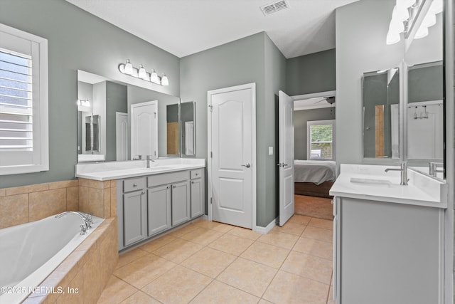 full bath featuring visible vents, ensuite bathroom, a sink, tile patterned flooring, and a bath