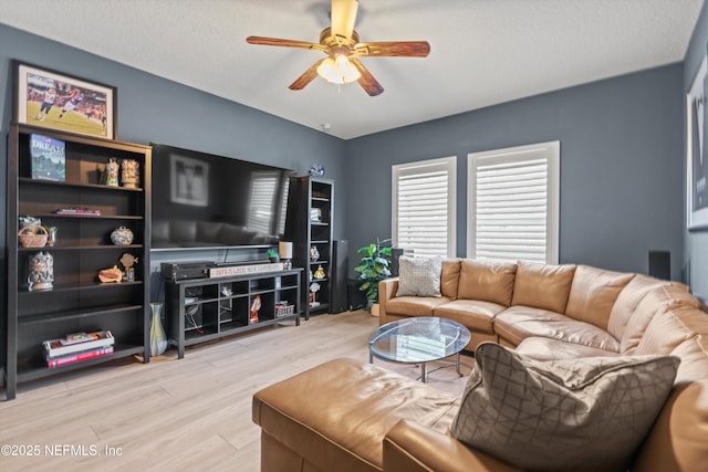 living area with light wood-style floors and ceiling fan