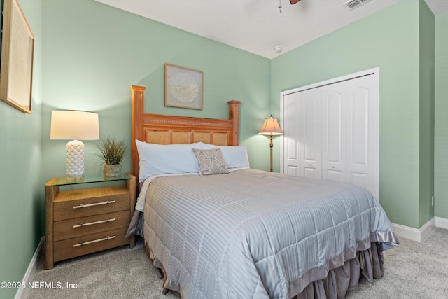 bedroom featuring light carpet, visible vents, baseboards, ceiling fan, and a closet