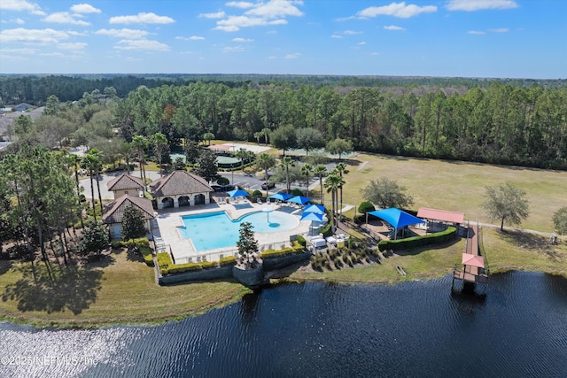 aerial view with a water view and a wooded view