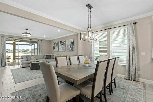 dining room with light tile patterned floors, ornamental molding, an inviting chandelier, and baseboards