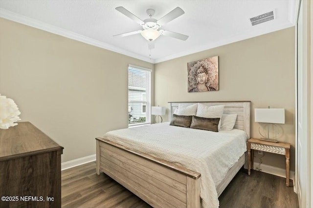 bedroom with crown molding, visible vents, and dark wood-style flooring