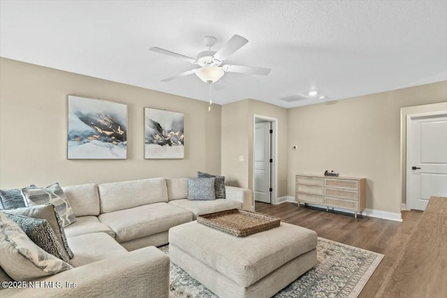 living room with ceiling fan, wood finished floors, and baseboards