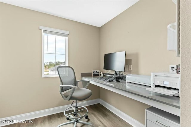 home office featuring baseboards and wood finished floors