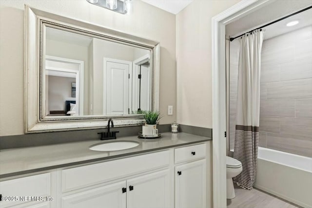 full bath with shower / bath combo with shower curtain, vanity, and toilet