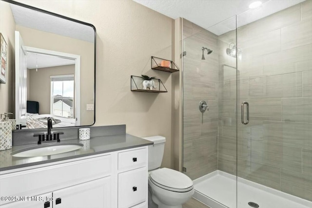 full bath with toilet, a stall shower, ensuite bath, and vanity