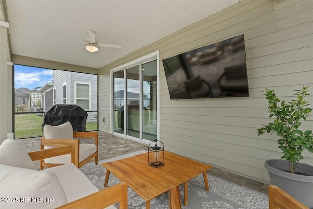 sunroom / solarium with a ceiling fan