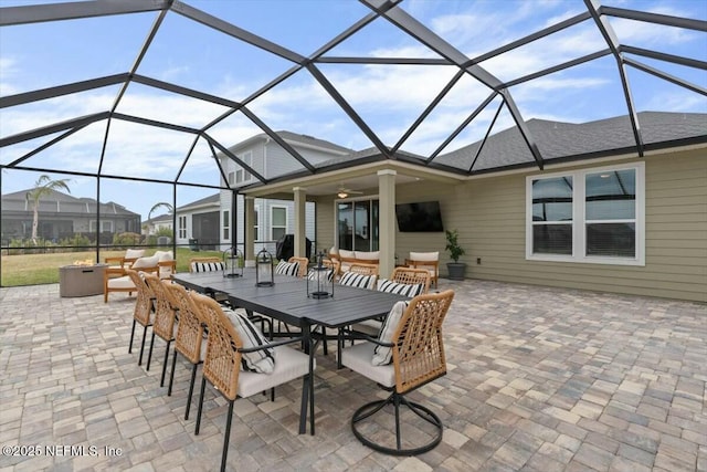 view of patio / terrace with outdoor dining area, ceiling fan, a lanai, and an outdoor hangout area