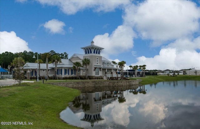 exterior space featuring a lawn and a water view