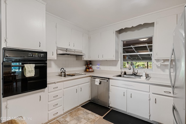 kitchen with decorative backsplash, white cabinets, appliances with stainless steel finishes, under cabinet range hood, and a sink