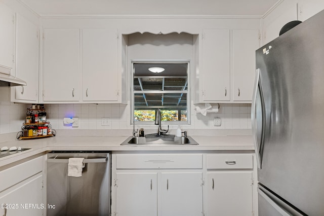 kitchen with decorative backsplash, white cabinets, appliances with stainless steel finishes, light countertops, and a sink