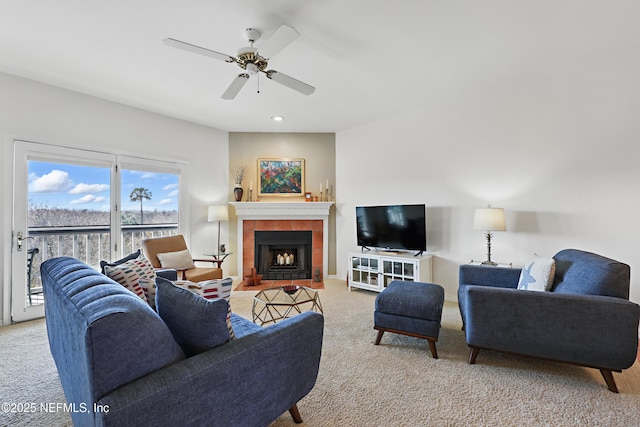 living room featuring recessed lighting, a ceiling fan, carpet flooring, and a tile fireplace