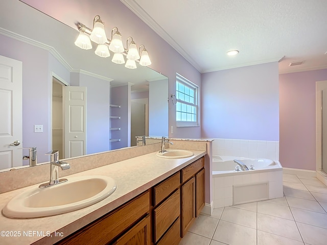 bathroom featuring tile patterned flooring, visible vents, ornamental molding, and a sink