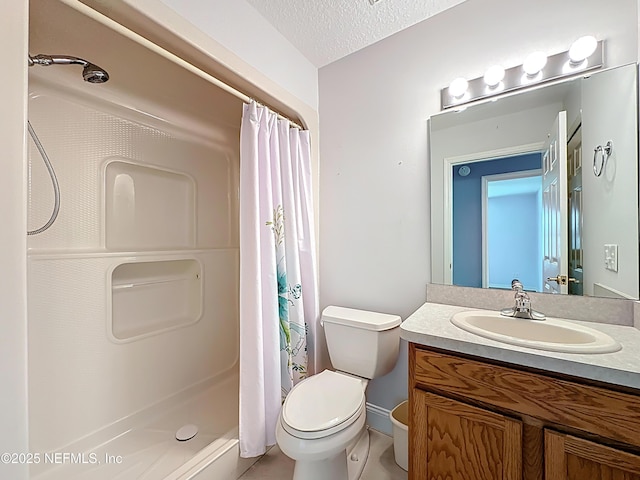 bathroom featuring a shower stall, a textured ceiling, vanity, and toilet