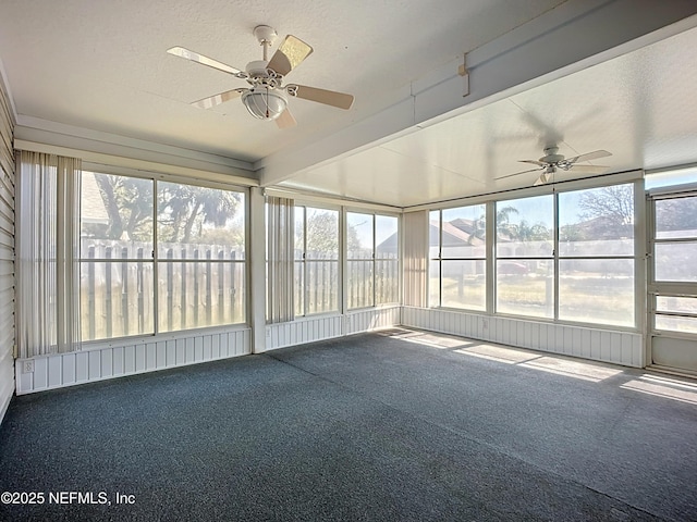 unfurnished sunroom featuring ceiling fan