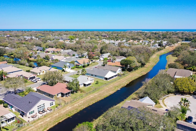 drone / aerial view with a residential view and a water view