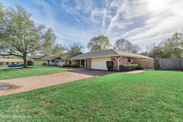 view of home's exterior with decorative driveway, brick siding, a yard, fence, and a garage