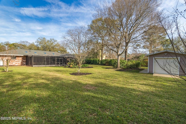 view of yard featuring a garage, a sunroom, and an outbuilding