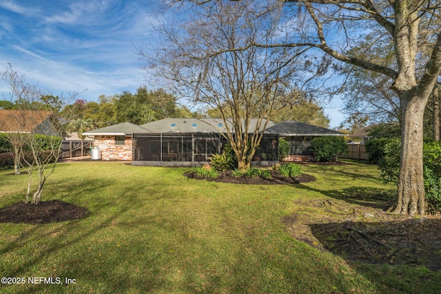 view of yard featuring a sunroom and fence