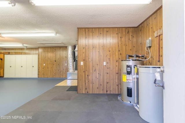 utility room with gas water heater and electric water heater