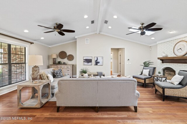 living area featuring lofted ceiling with beams, light wood-style flooring, visible vents, and crown molding