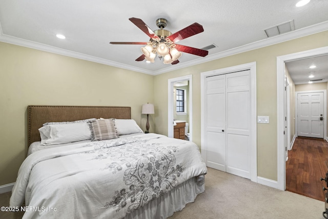 bedroom with ornamental molding, a closet, visible vents, and baseboards