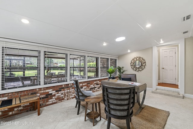 tiled dining space with baseboards, brick wall, visible vents, and recessed lighting