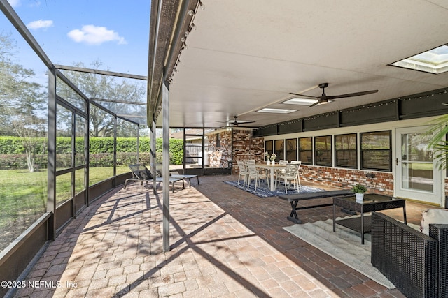 unfurnished sunroom featuring a ceiling fan