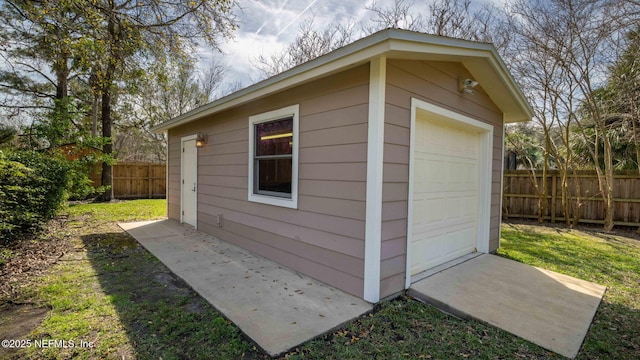 view of outdoor structure with an outbuilding and fence