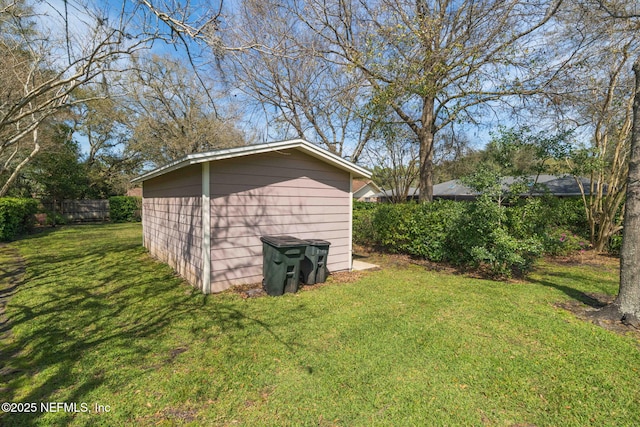 view of shed featuring fence