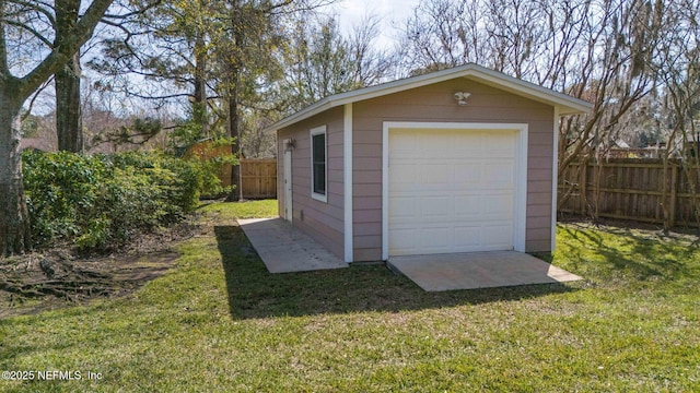 detached garage featuring fence