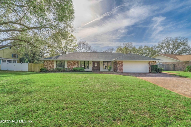 ranch-style house with a garage, decorative driveway, a front yard, and fence