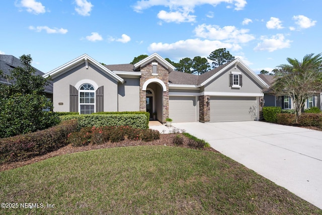 view of front facade featuring stucco siding, an attached garage, a front yard, stone siding, and driveway