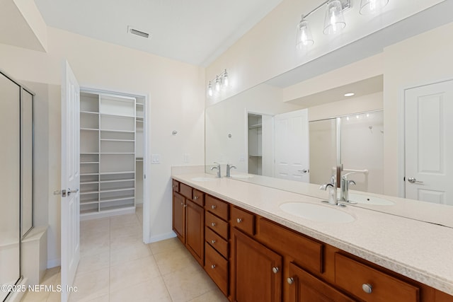 bathroom featuring double vanity, tile patterned flooring, and a sink