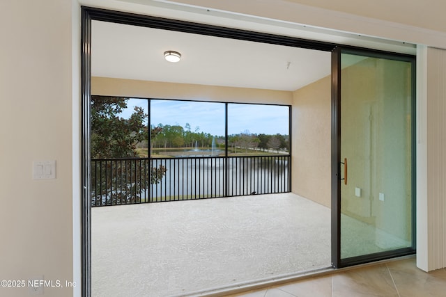 unfurnished sunroom with a water view