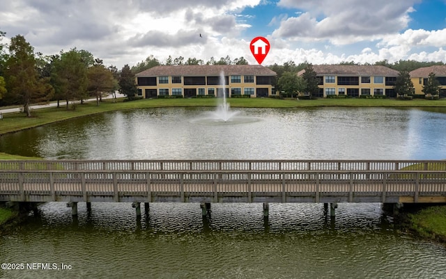 dock area featuring a lawn and a water view