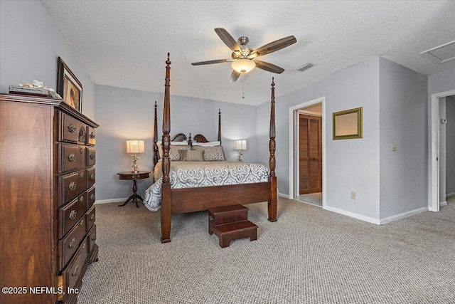 carpeted bedroom with baseboards, visible vents, and a textured ceiling