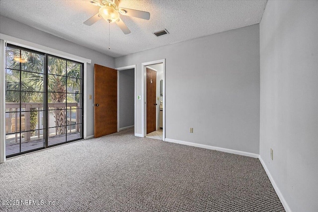 carpeted spare room featuring a textured ceiling, ceiling fan, visible vents, and baseboards