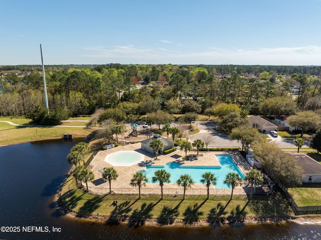 aerial view with a water view and a wooded view