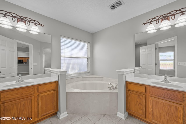 bathroom featuring two vanities, visible vents, a sink, and tile patterned floors