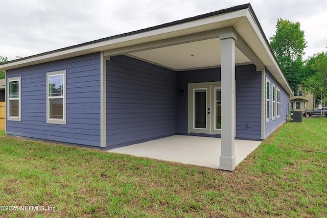 back of house featuring a yard, french doors, a patio, and cooling unit